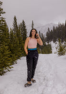 Woman wearing Nexarina Black Willow Sweatpants front view on the mountain.