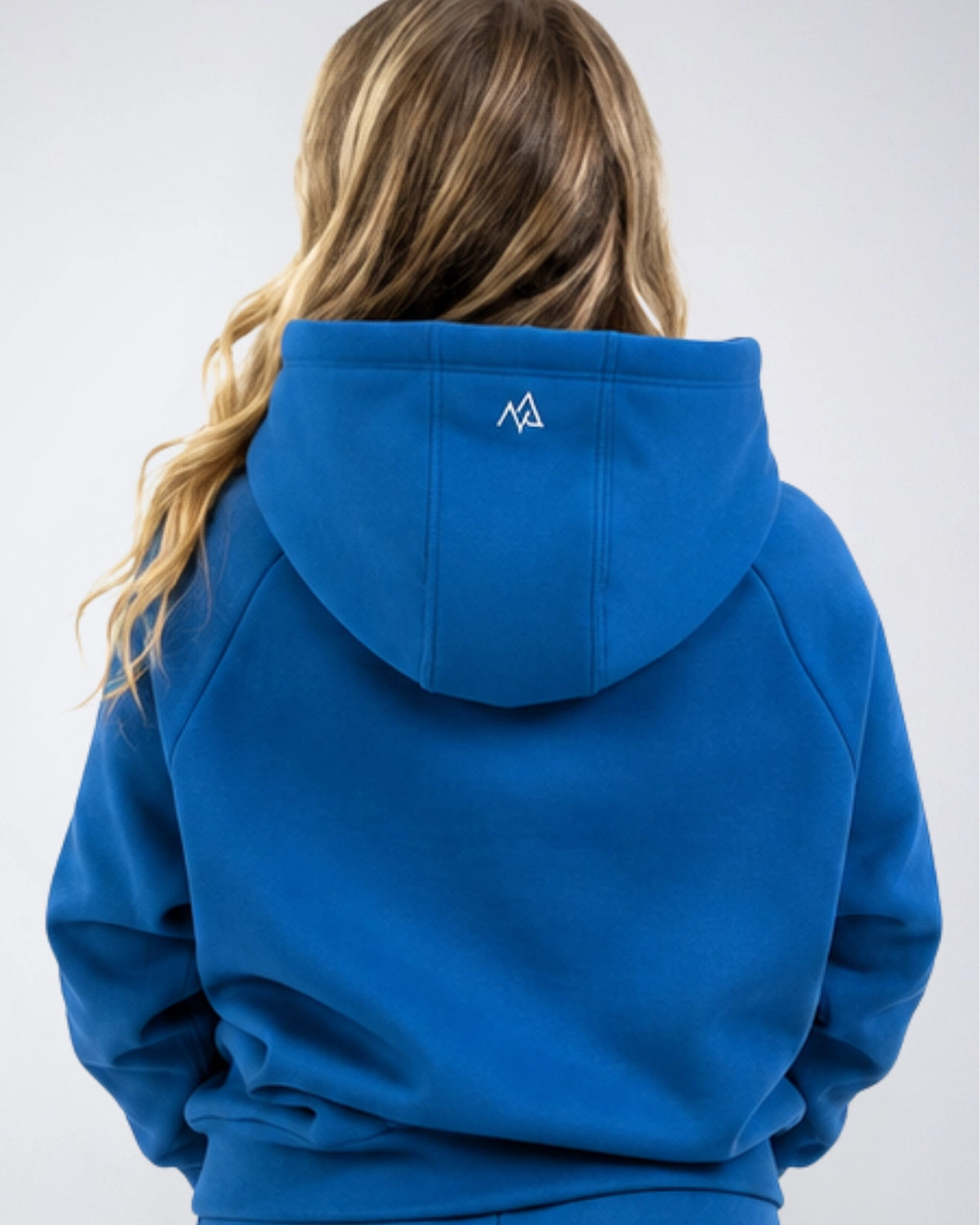 Back view of the Nexarina Everly Hoodie in Dusty Blue showing the hood and back logo