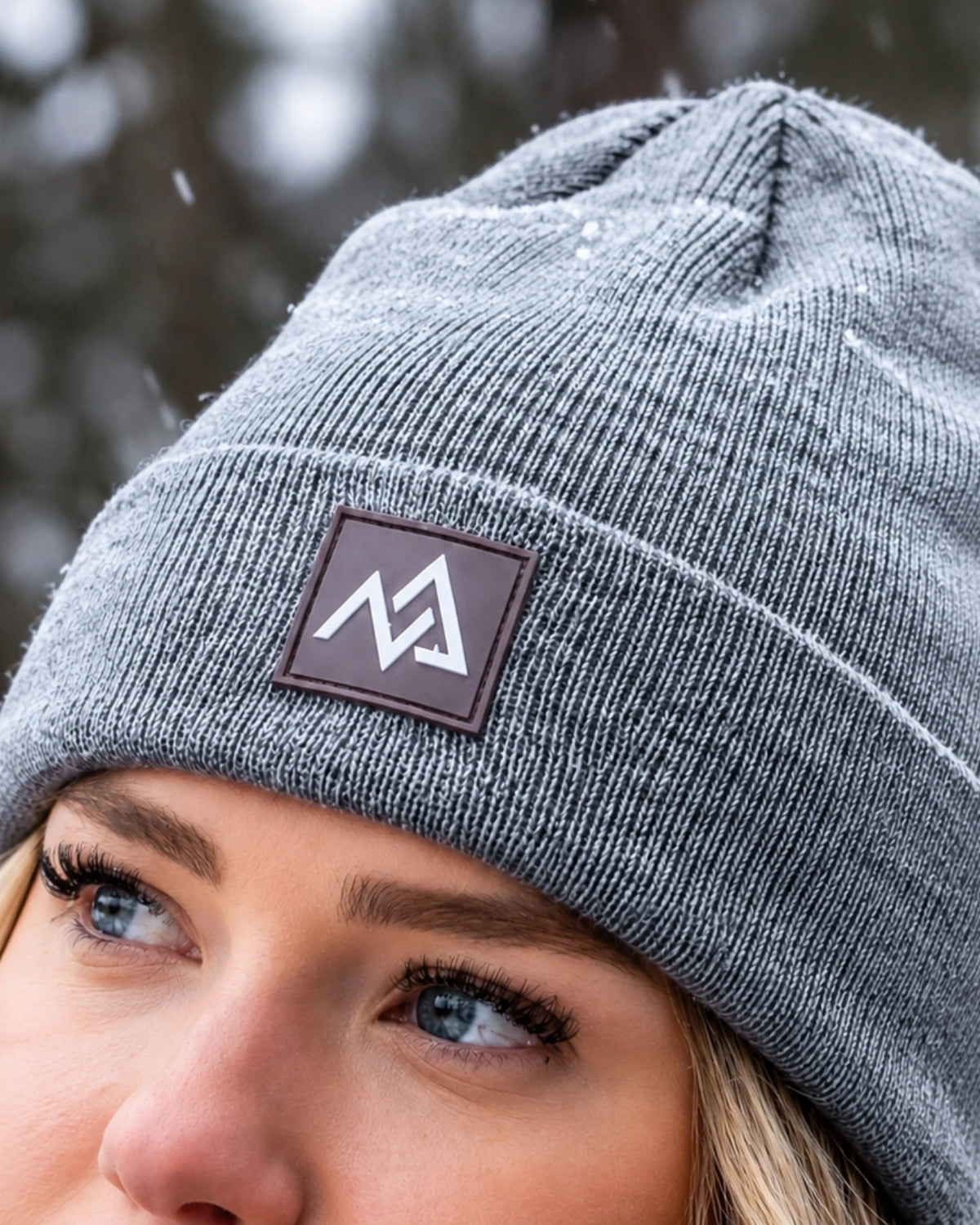 Close-up of Nexarina logo on grey Emery Beanie