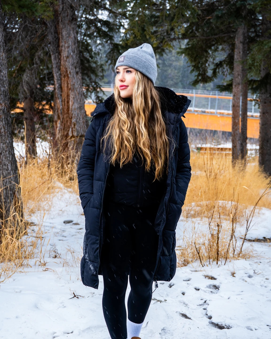Women in grey Emery beanie wearing a mountain style outfit.