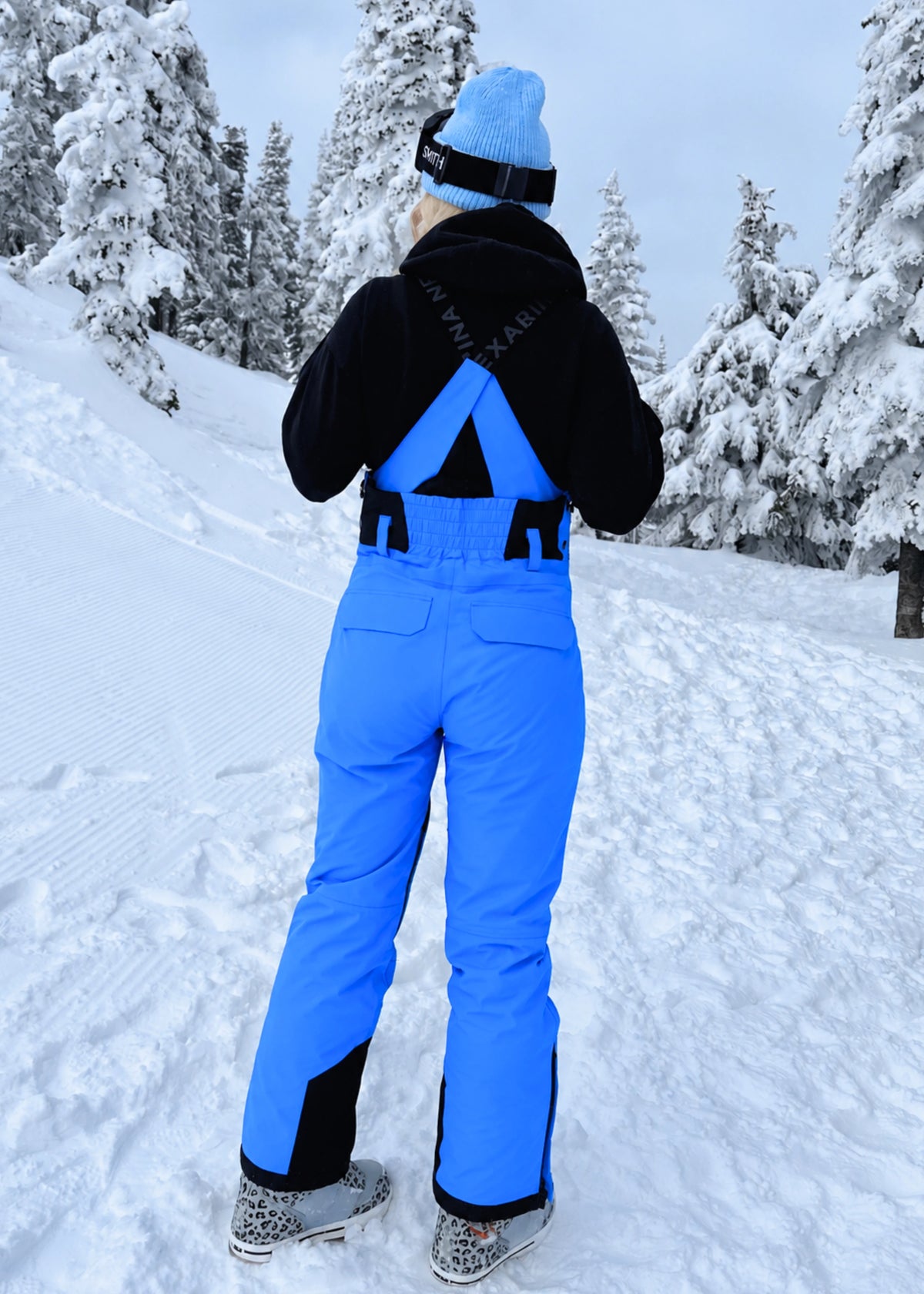 Back view of Nexarina Everette Arctic Blue women's snow bibs showing the fit and adjustable shoulder straps.