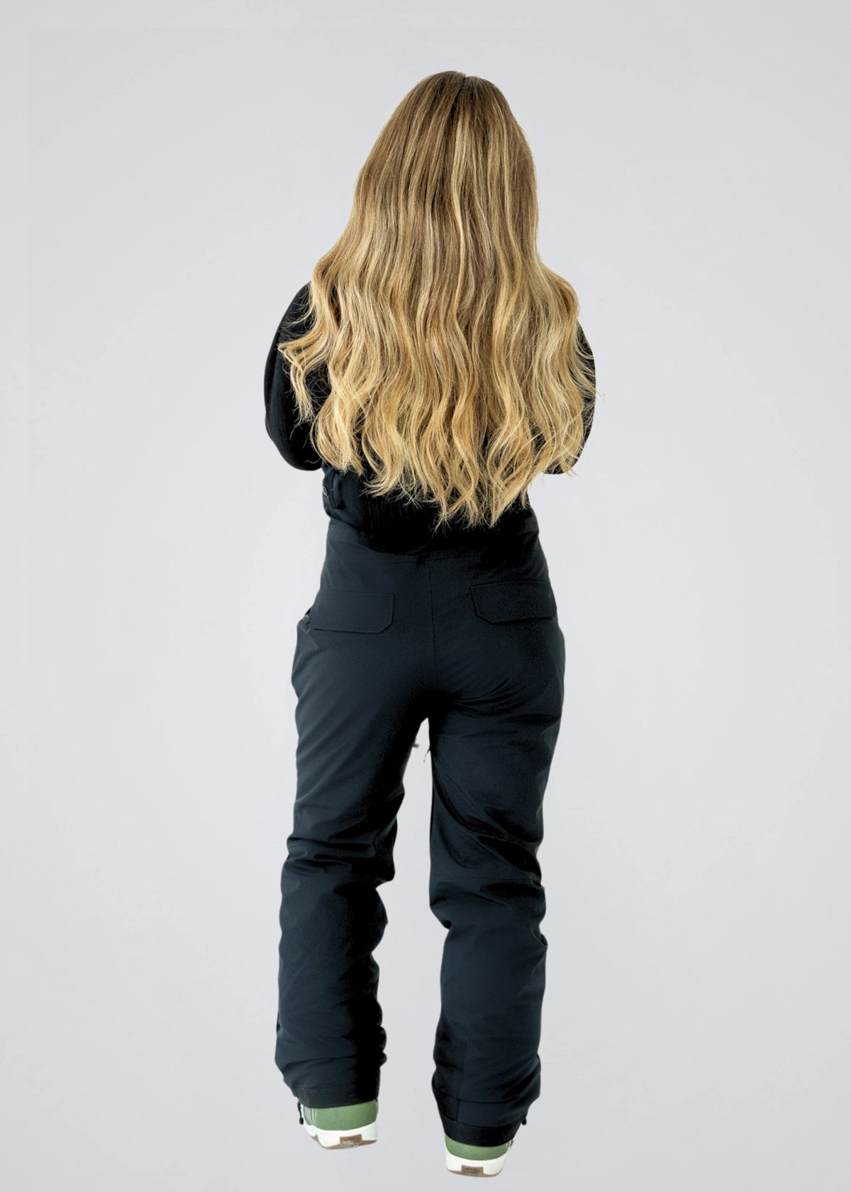 Full-length rear view of Nexarina Everette Classic Black women's snow bibs showing the fit, rear pockets and leg length.
