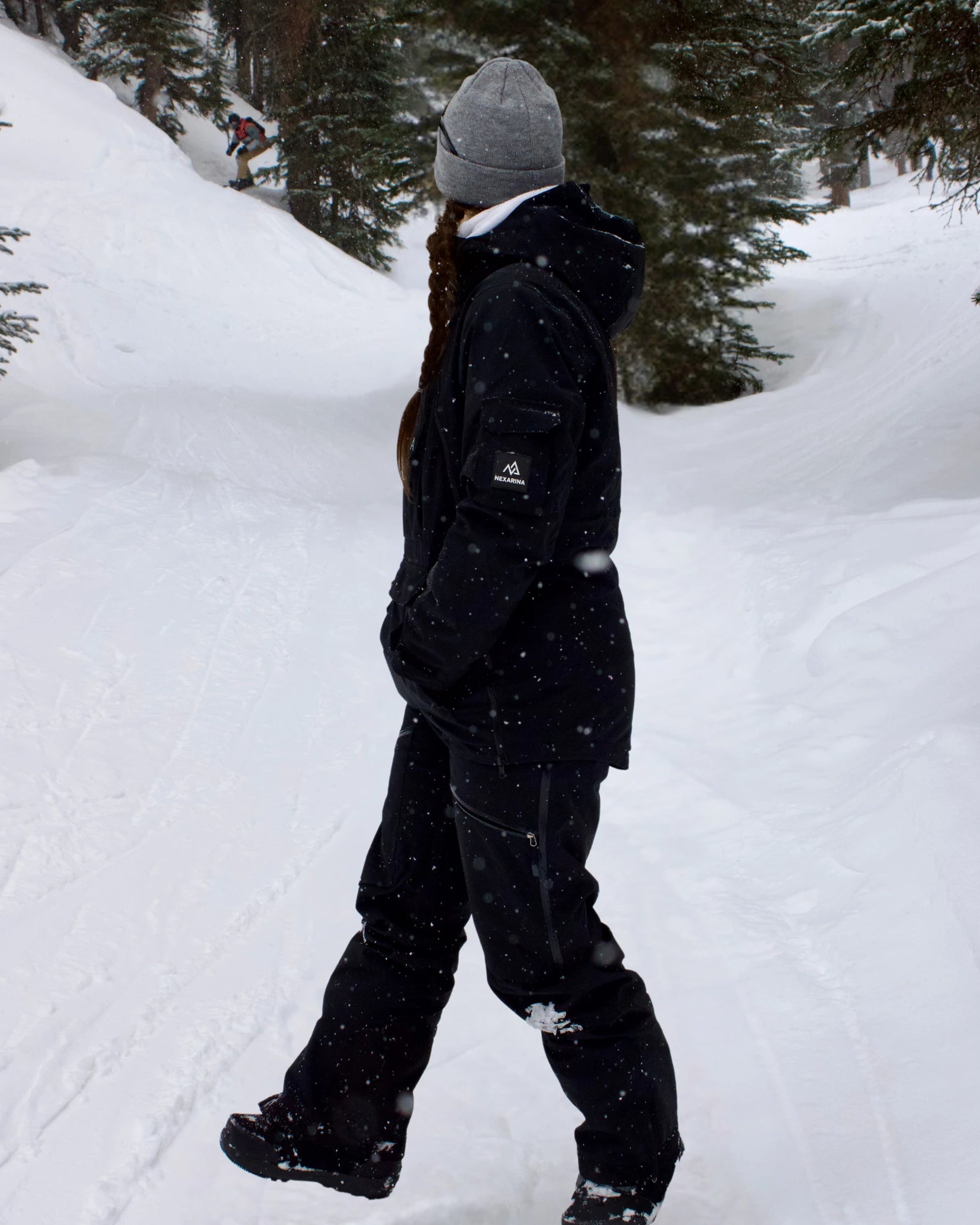 Side view of woman in Nexarina Everette Bib black women’s technical outerwear.