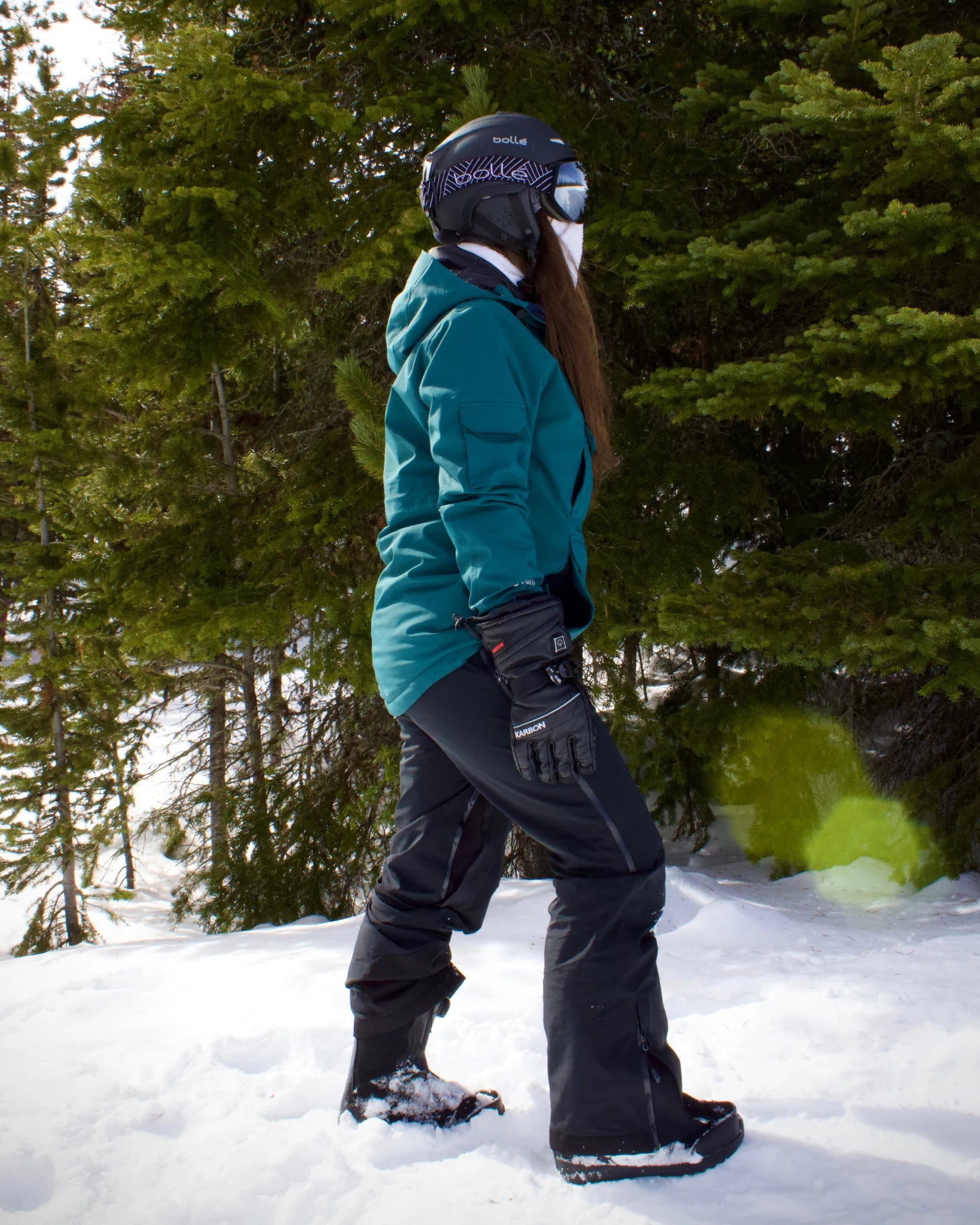 Woman wearing Nexarina Everette Bib under a snowboard jacket in black outerwear.
