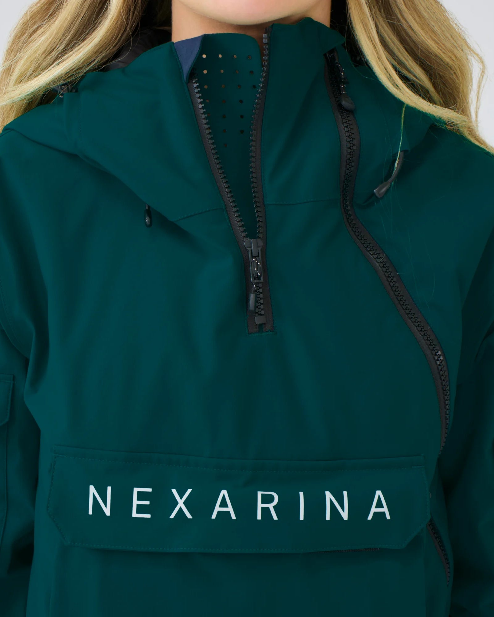 Close-up of Nexarina Indy Jacket in Emerald Green showing fabric texture, zippers, and premium finish.