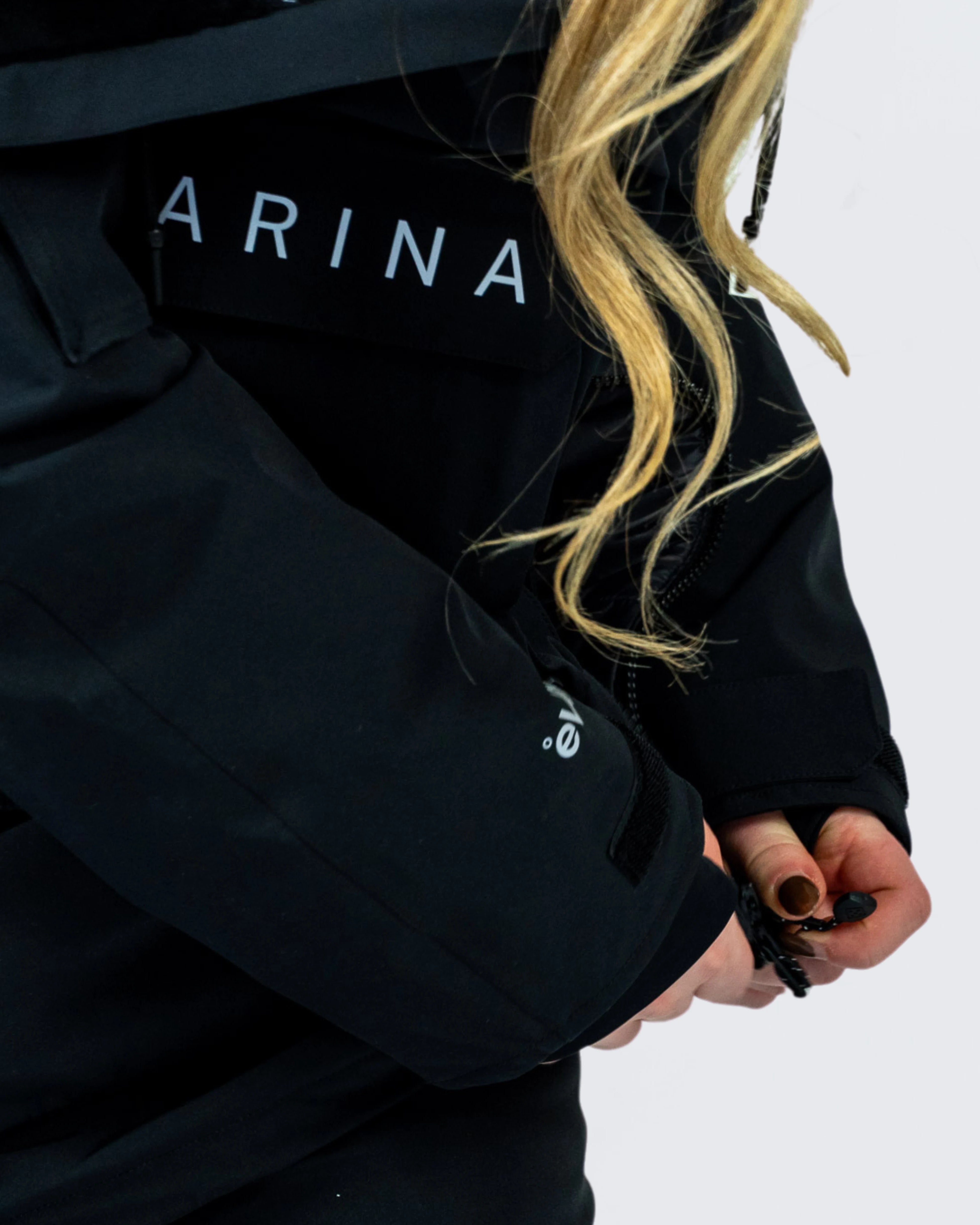Close-up of Nexarina Indy Snow Jacket being zipped up, with eVent® sleeve detail and drawcord in use.