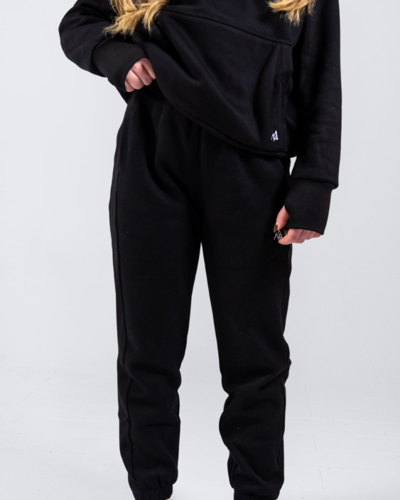 Woman wearing Nexarina Midnight Black Sweatpants showing front detail.