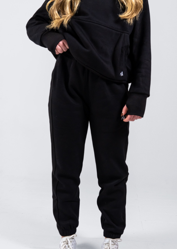 Woman wearing Nexarina Midnight Black Sweatpants showing front detail.
