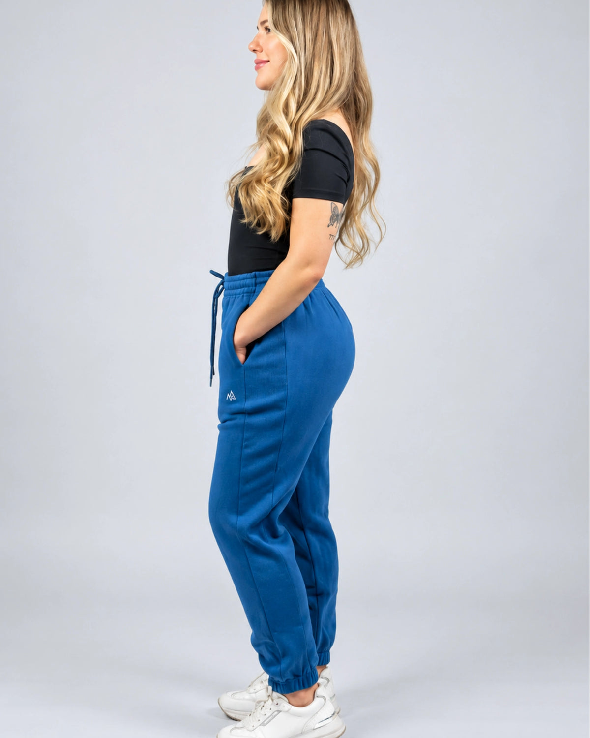 Side view of the women's Willow Sweatpants in Dusty Blue showing the hip fit and side panel.