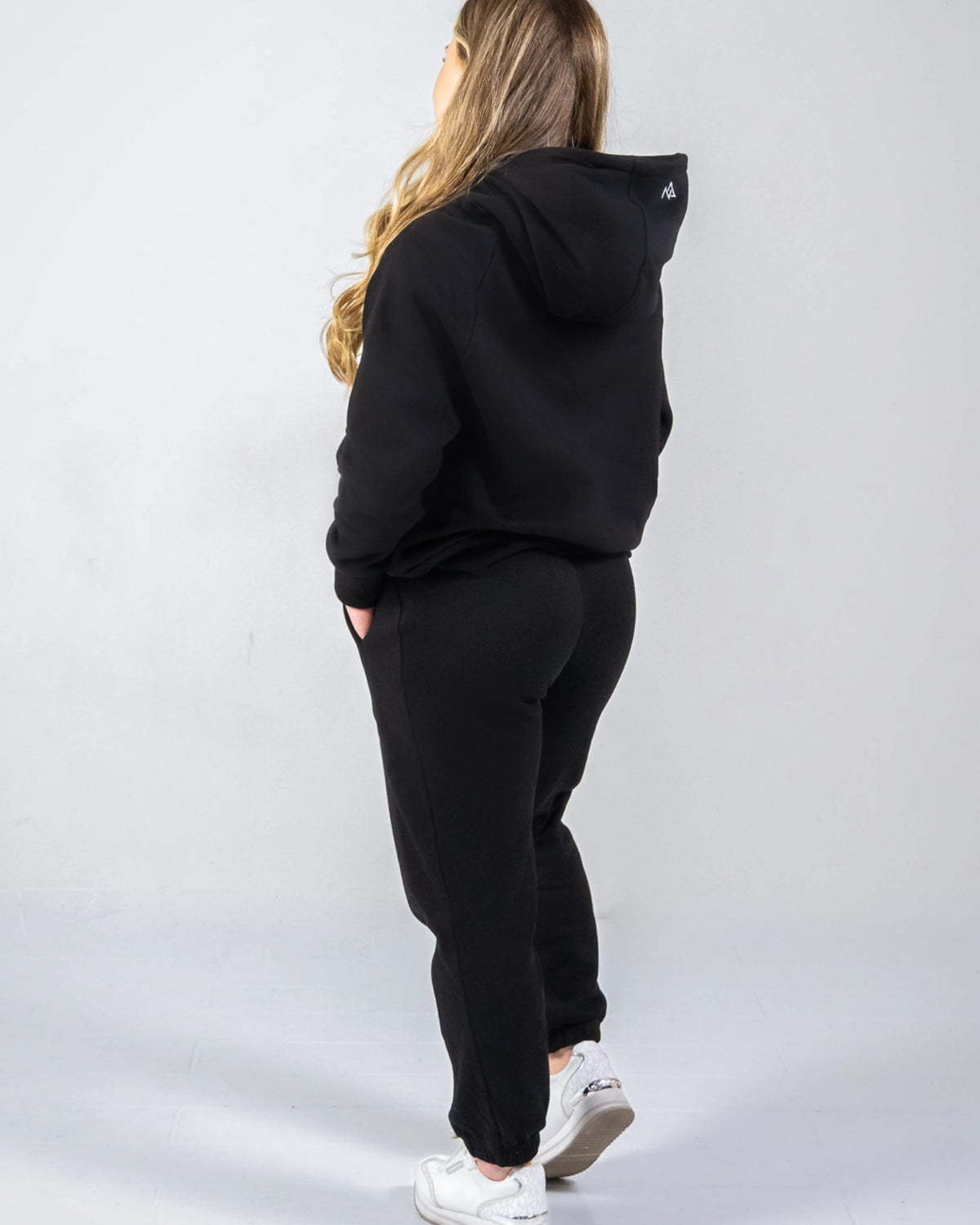 Woman wearing Midnight Black Nexarina sweatpants from the back