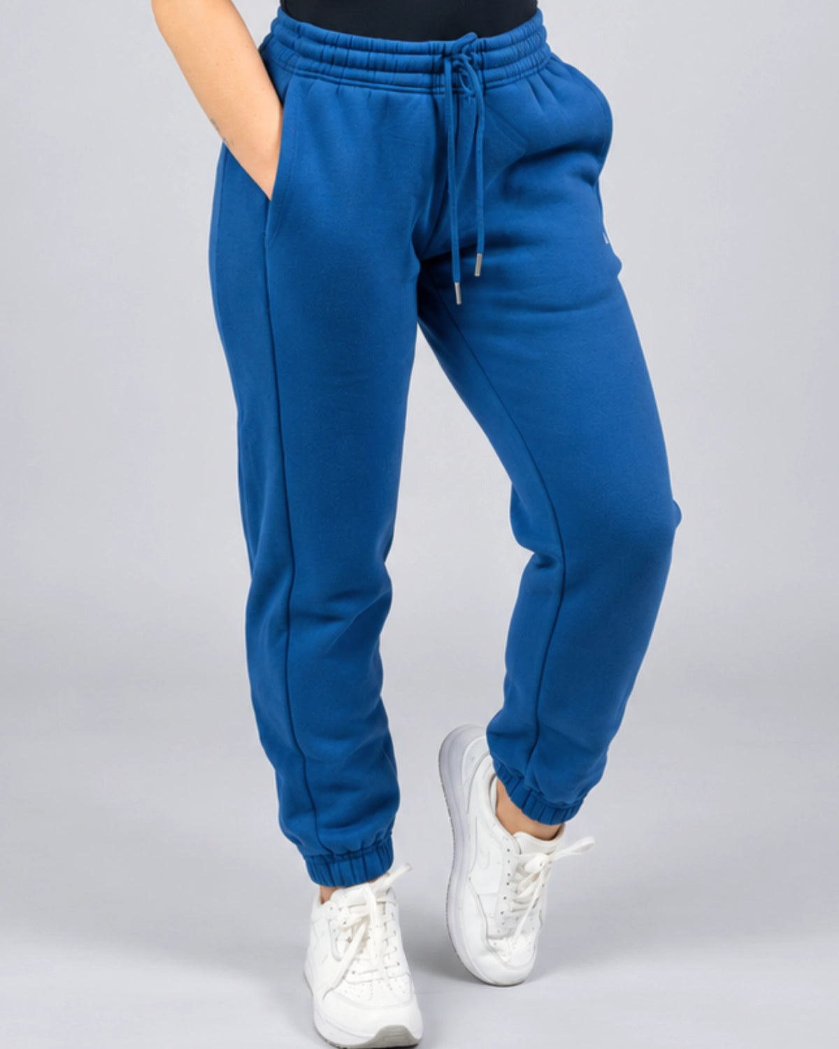 Close-up front view of the Willow women's sweatpants in Dusty Blue showing the waistband, drawcord, pockets and leg shape.
