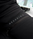 Close-up of Nexarina Avani Snow Pants showing waterproof zipper and printed Nexarina logo.