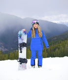 Woman snowboarding in Arctic Blue Nexarina bib pants and technical outerwear.