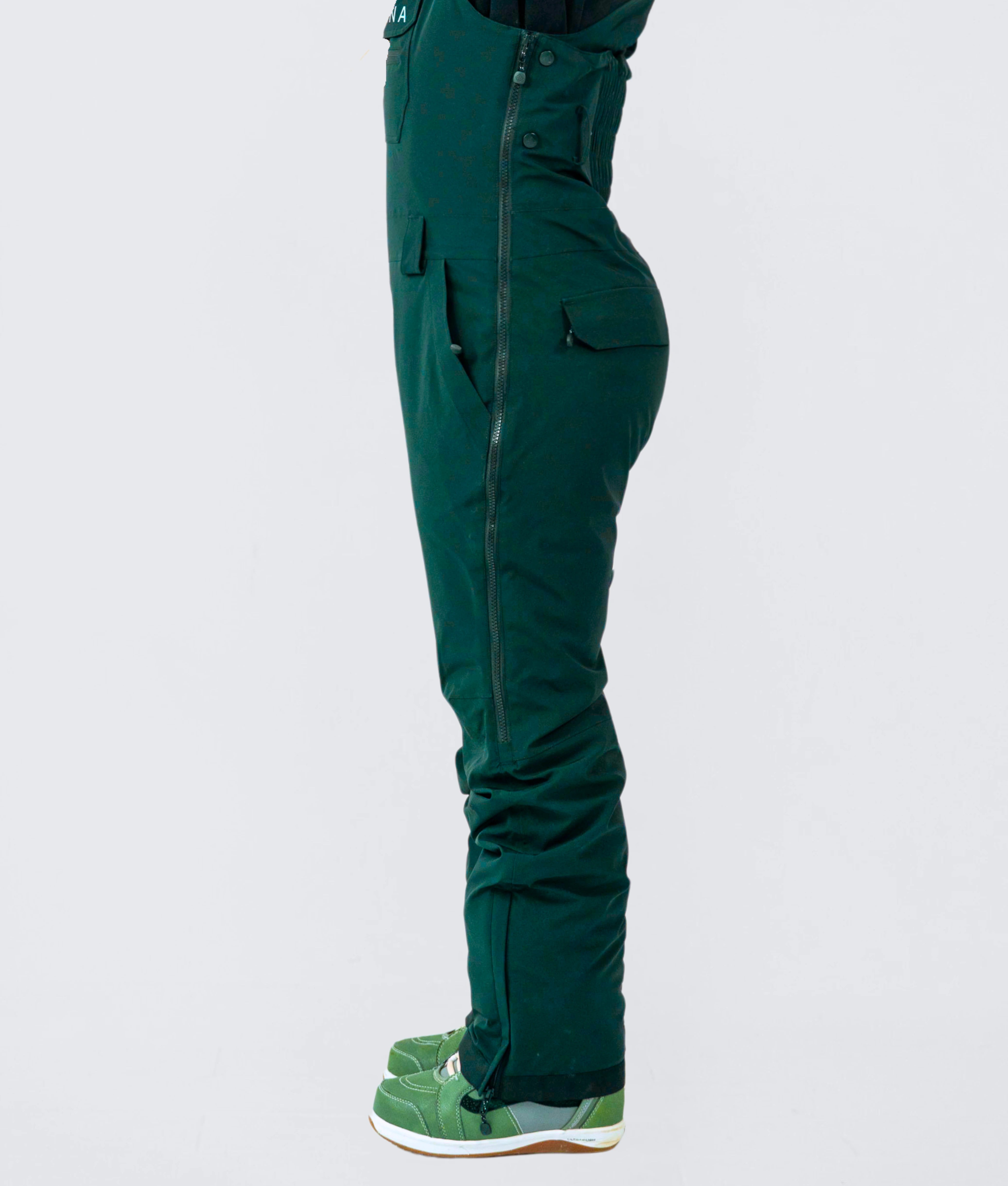 Emerald green women's snow bibs with adjustable fit, breathable and waterproof for skiing and snowboarding
