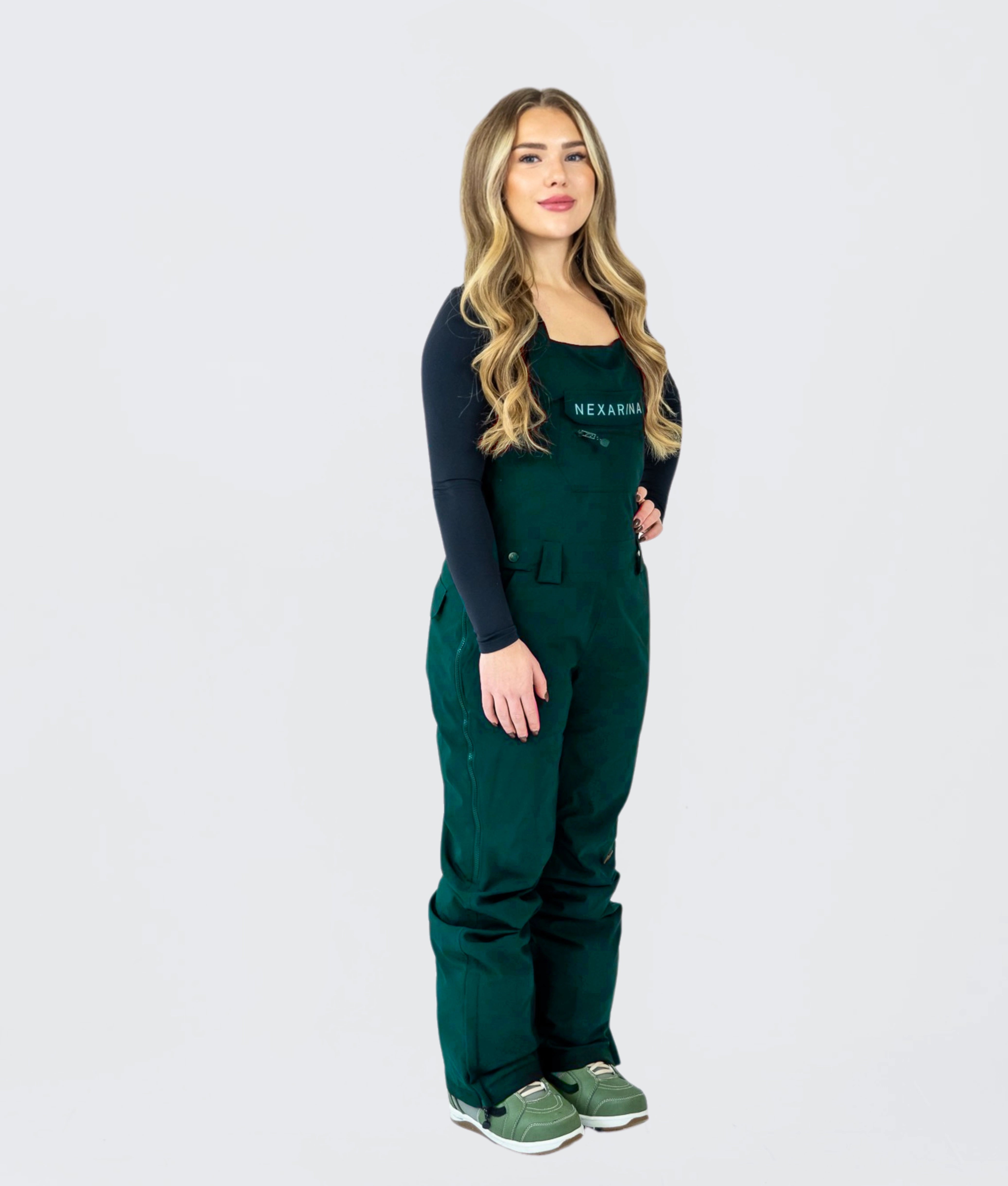 Full-body view of women's green snow bib pants, designed for snowboarding and mountain adventures.