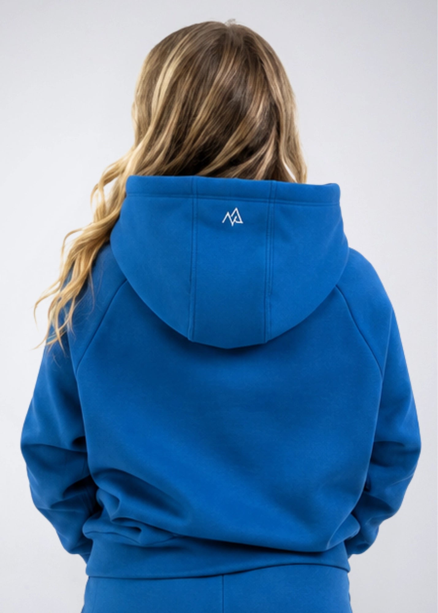 Back view of the Nexarina Everly Hoodie in Dusty Blue showing the hood and back logo