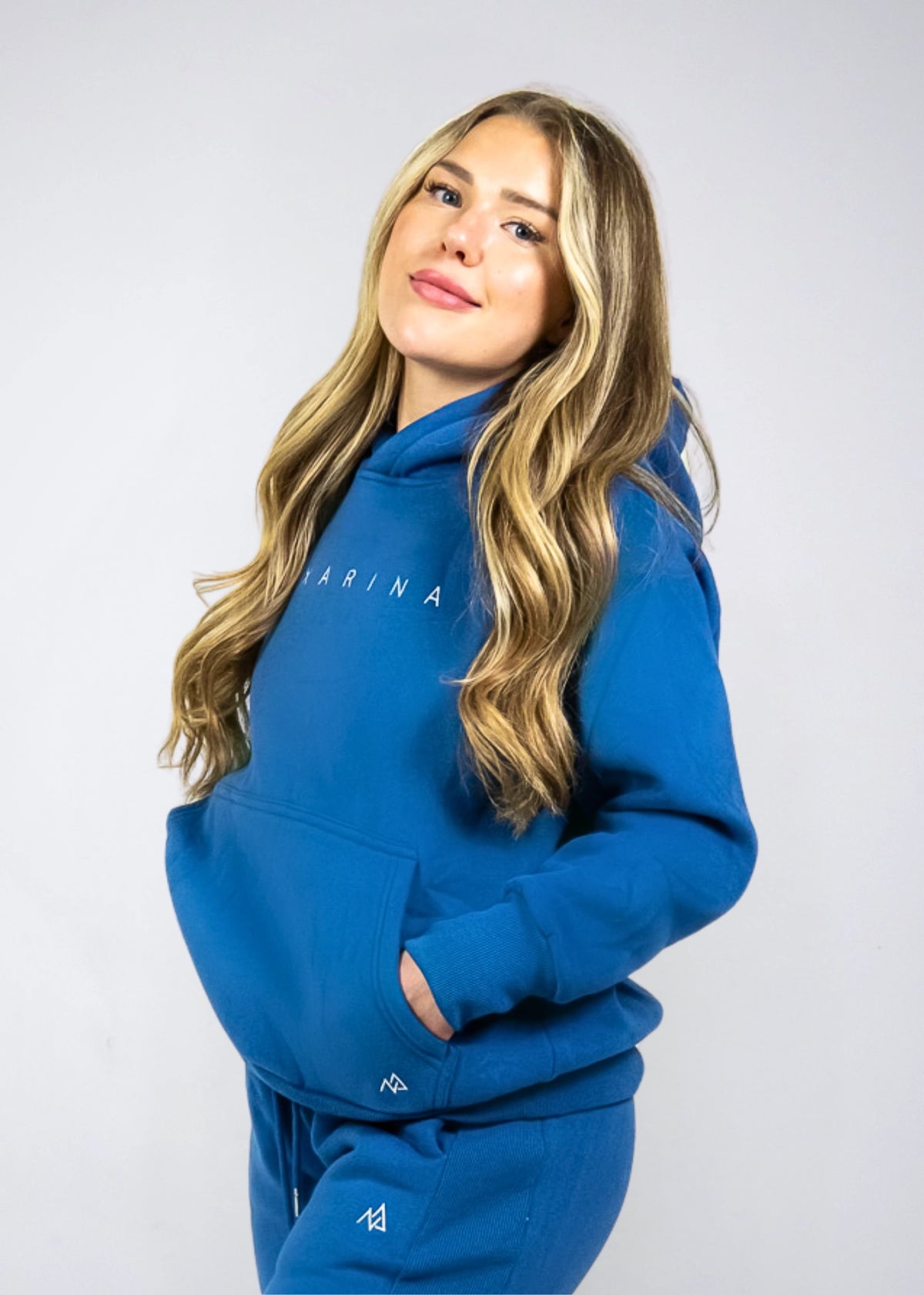 Woman wearing the Nexarina Everly Hoodie in Dusty Blue, front view