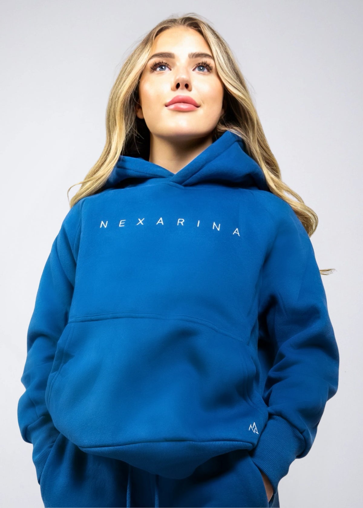 Front view of the Nexarina Everly Hoodie in Dusty Blue on a woman