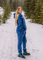 Women's Everly Hoodie in Dusty Blue worn with matching sweatpants in a snowy mountain setting.