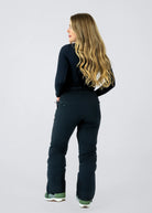 Rear view of Nexarina Everette Classic Black women's snow bibs showing the back pockets, fitted waist and leg design.
