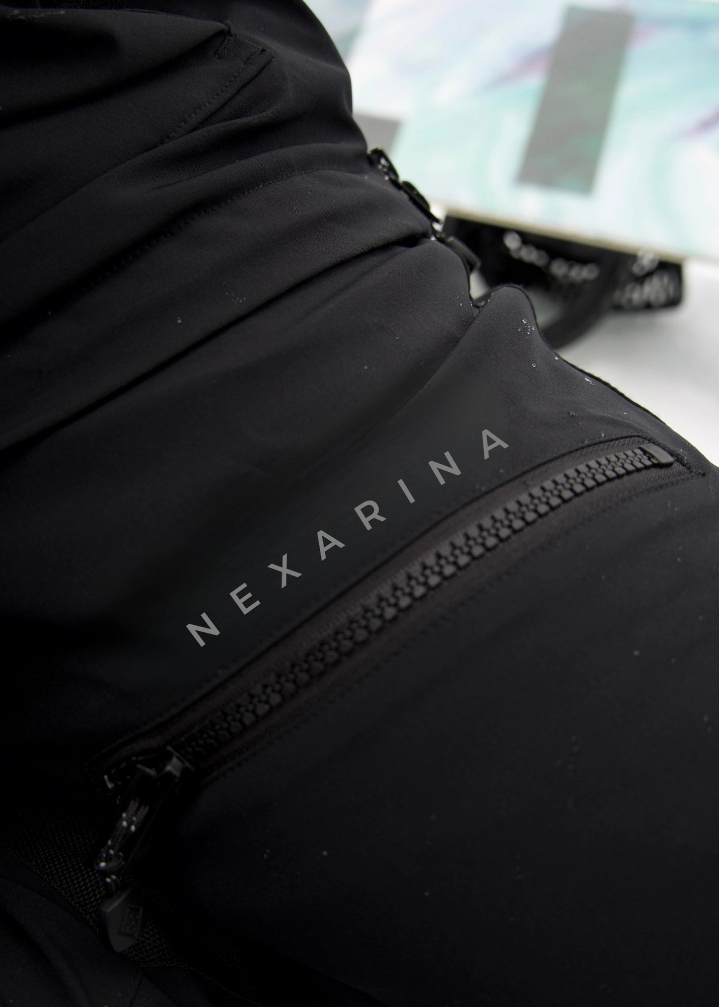 Nexarina Avani women's black snowboard pants Nexarina logo fabric detail