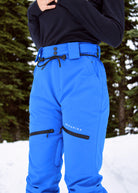 Close-up of Nexarina Avani Arctic Blue snow pants featuring the adjustable waist belt, zippered thigh pockets and Nexarina logo.