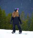 Snowboarder wearing Nexarina black Avani Snow Pant riding on a snowy mountain.