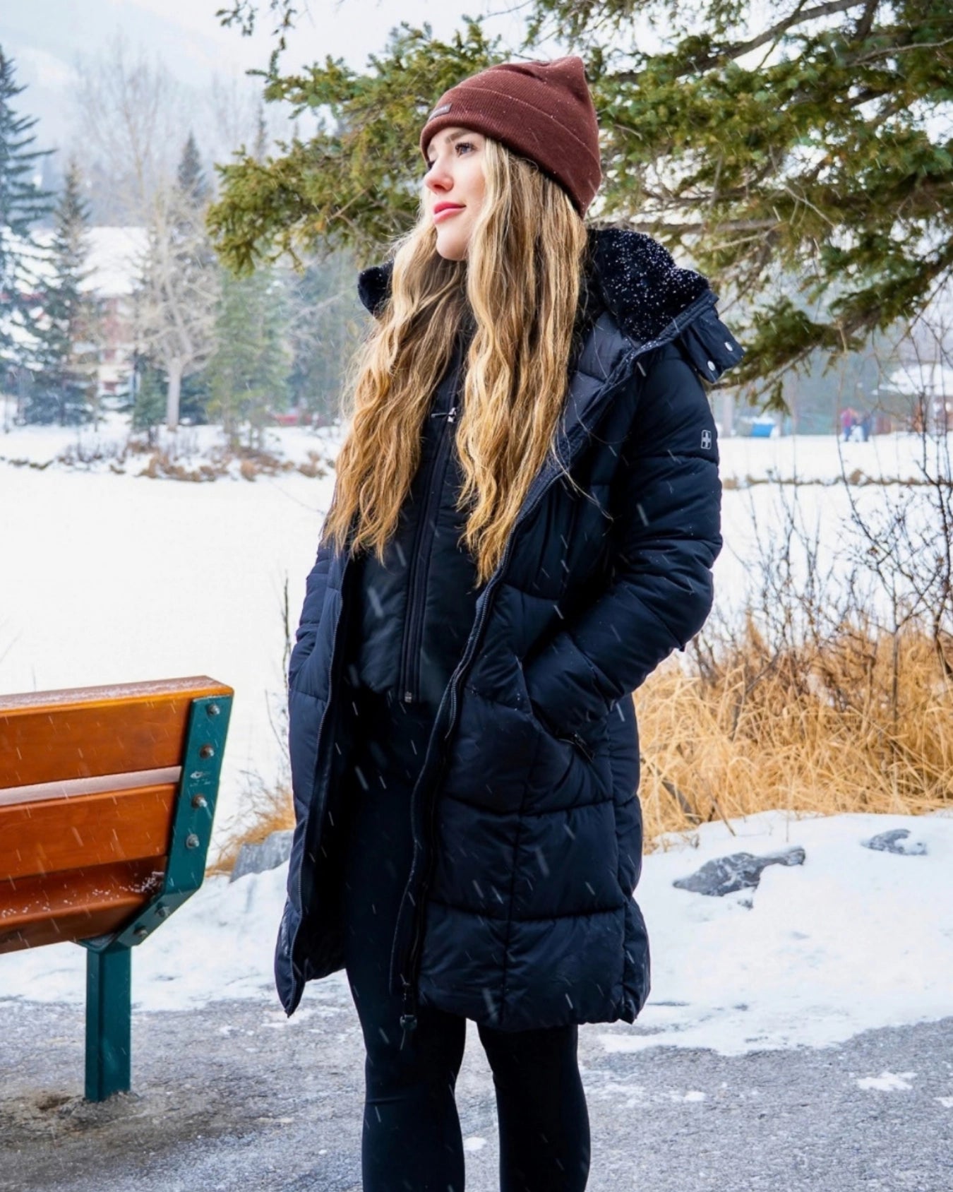 Woman wearing the Nexarina Coco brown beanie with a black winter jacket