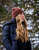 Side view of woman wearing the Nexarina Coco brown beanie outdoors