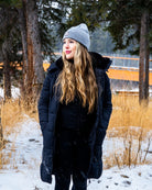 Full-body view wearing grey Emery Beanie in snowy setting