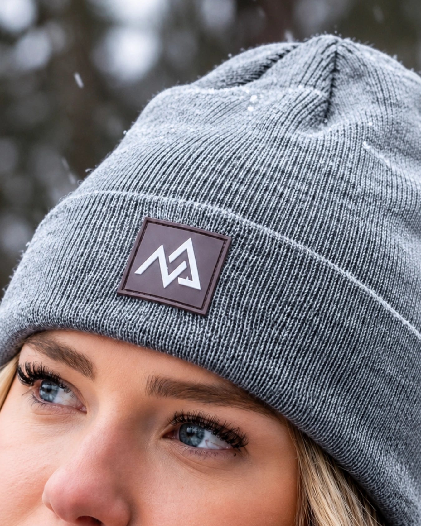 Close-up of Nexarina logo on grey Emery Beanie