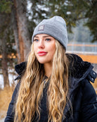 Woman wearing grey Emery Beanie with black winter jacket