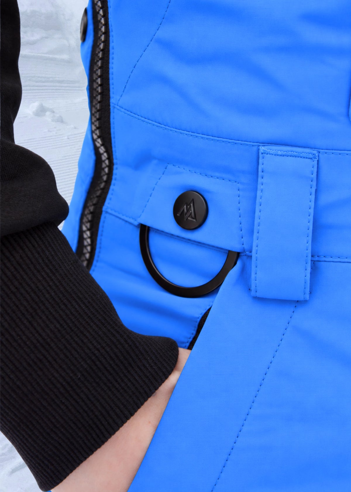 Detail of Nexarina Everette Arctic Blue women's snow bibs featuring the hip pocket and attachment loop.