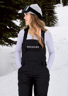 Nexarina Everette Classic Black snow bibs showing the zippered chest pocket, branded shoulder straps and Nexarina logo.