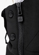 Close-up of Nexarina Everette Classic Black snow bibs showing the side zipper, branded puller and snap buttons.