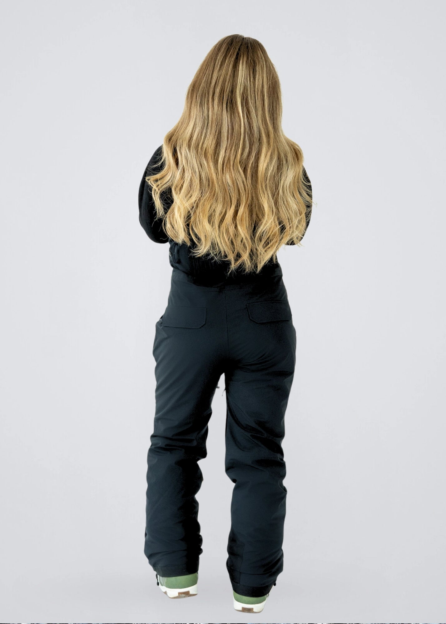 Nexarina Everette women's black snowboard bib pants back view studio