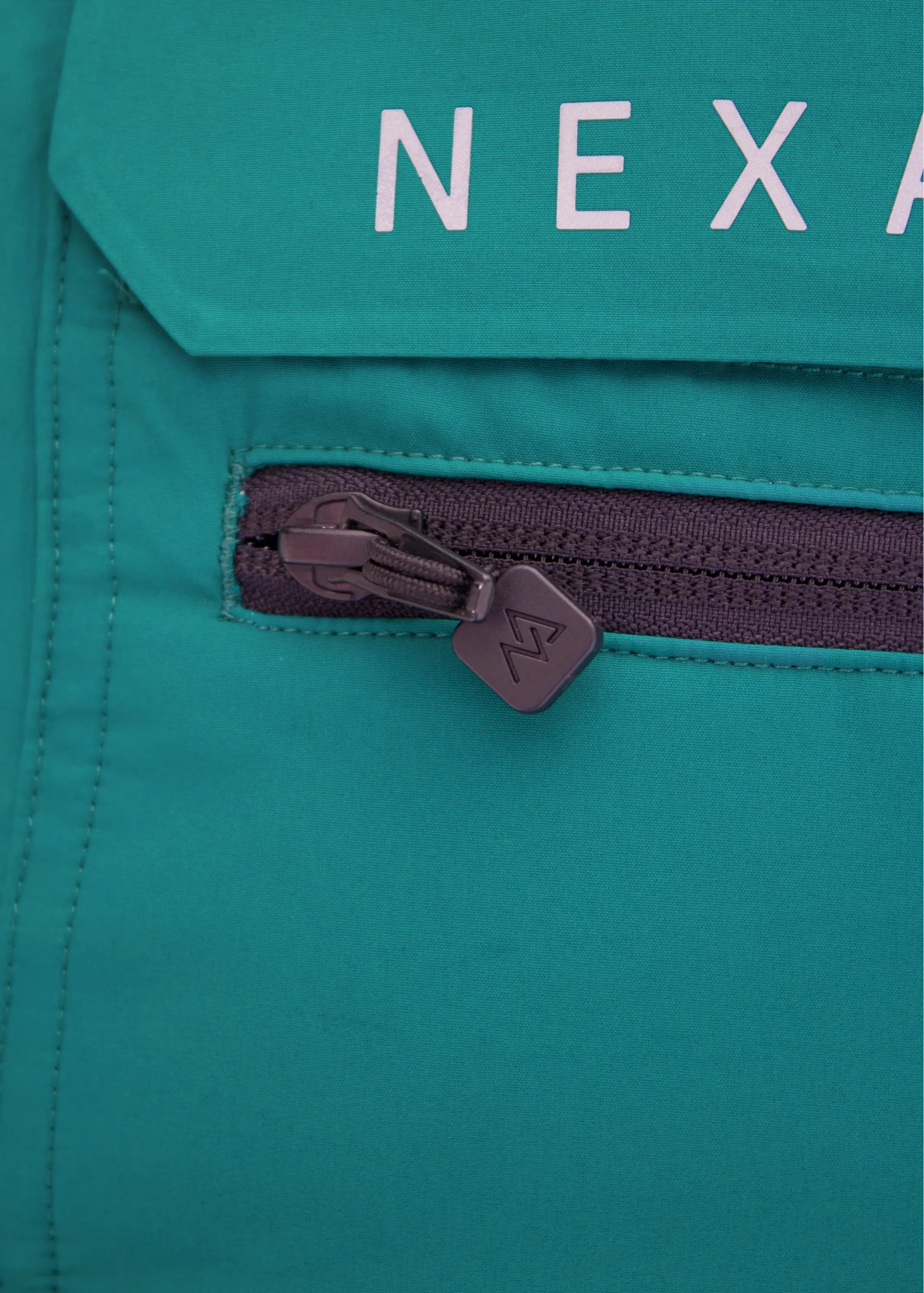 Close-up of Nexarina Everette Emerald Green bib chest pocket and Nexarina branding.