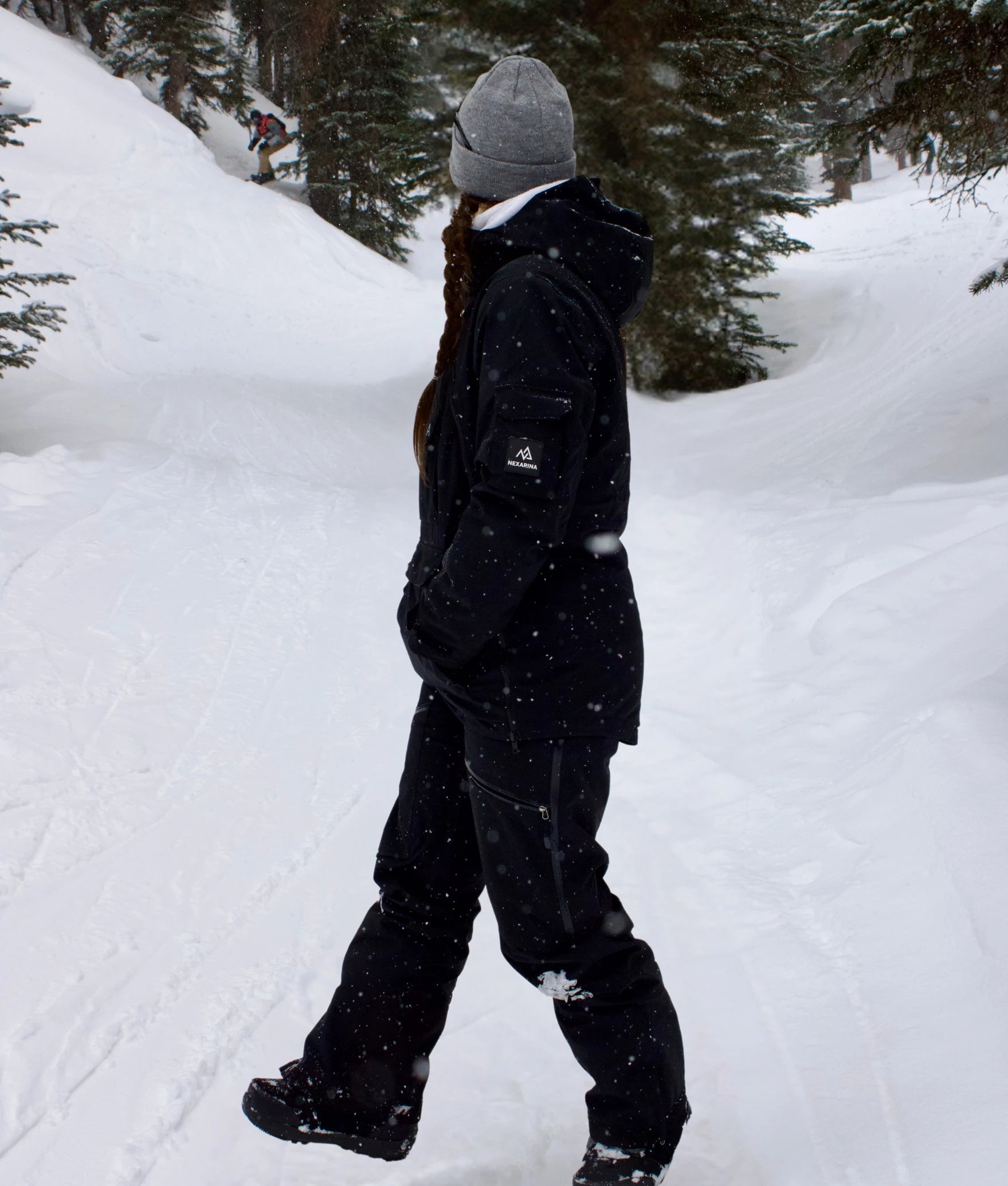 Side view of woman in Nexarina Everette Bib black women’s technical outerwear.