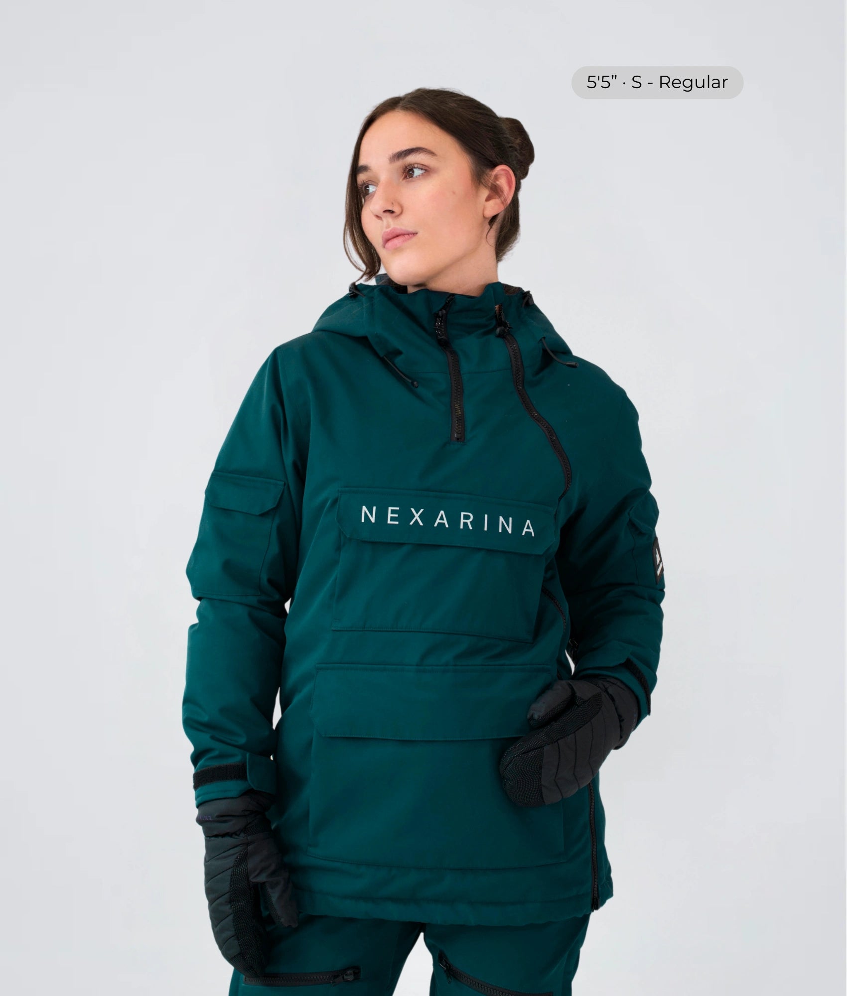 Model wearing Nexarina Indy snow jacket in emerald green, studio front view