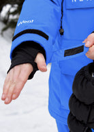 Close-up of Nexarina Indy Arctic Blue ski jacket featuring the adjustable Velcro cuff, thumbhole wrist gaiter and eVent fabric branding.