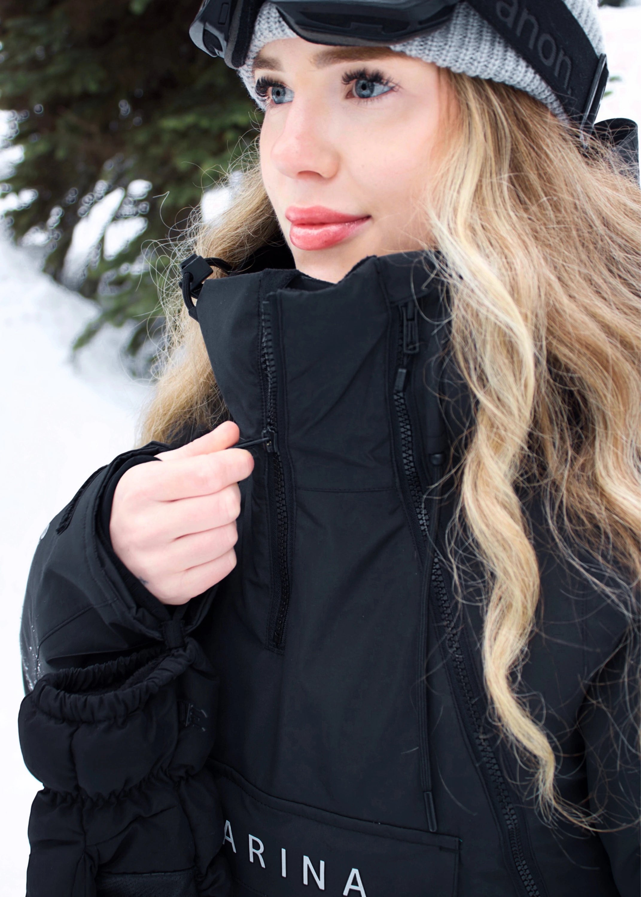 Close-up of woman wearing Nexarina Indy Classic Black ski jacket, showing the high collar and front zipper.