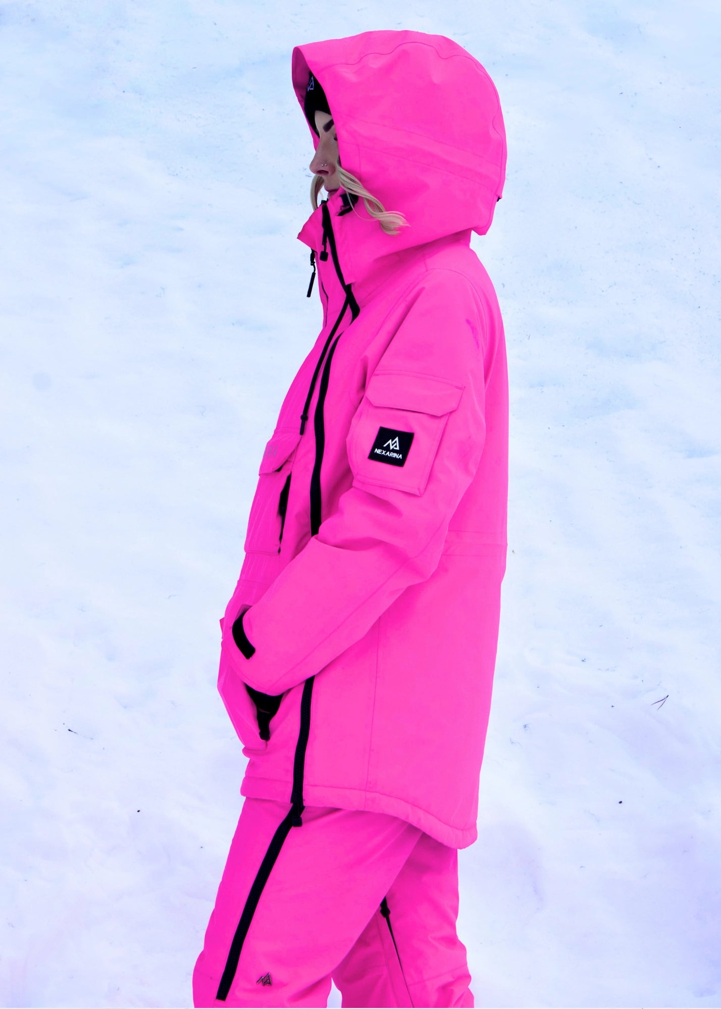 Women’s Nexarina Indy Snow Jacket in Electric Pink side profile with hood up