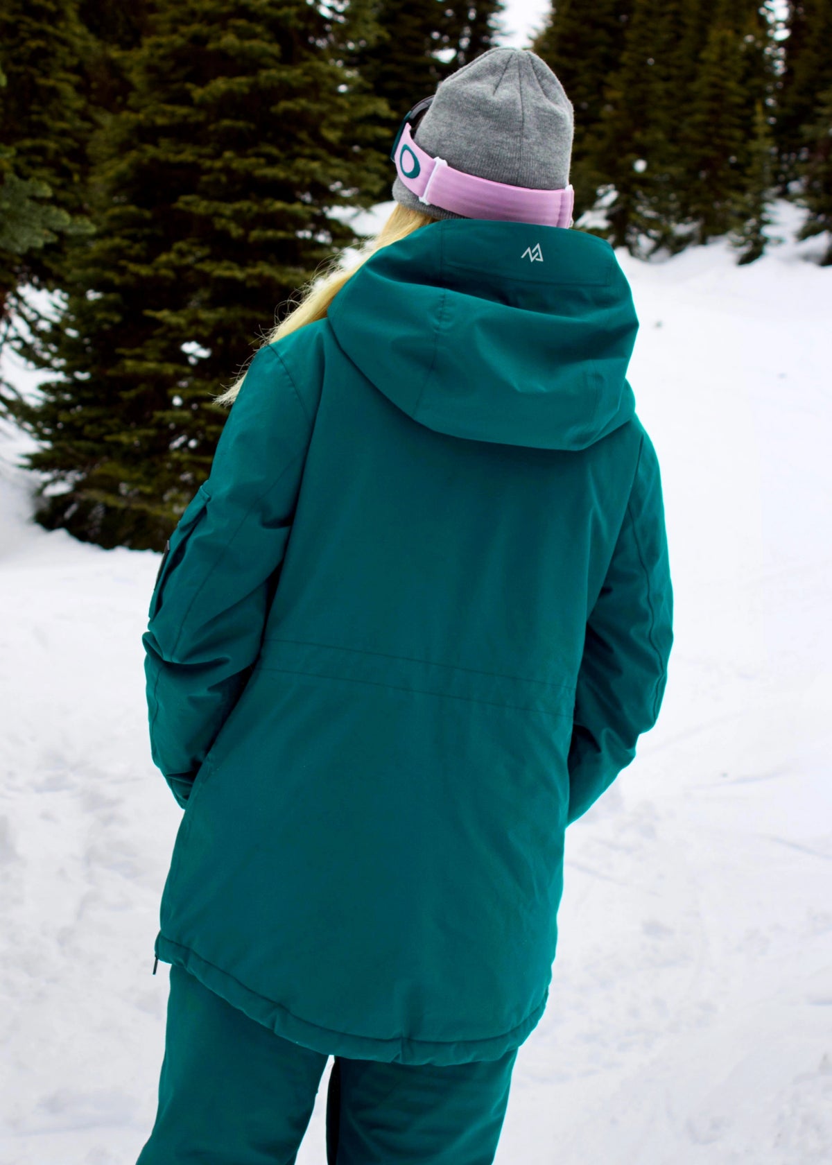 Back view of Nexarina Indy Emerald Green women's ski jacket showing the hood, jacket length and rear fit.