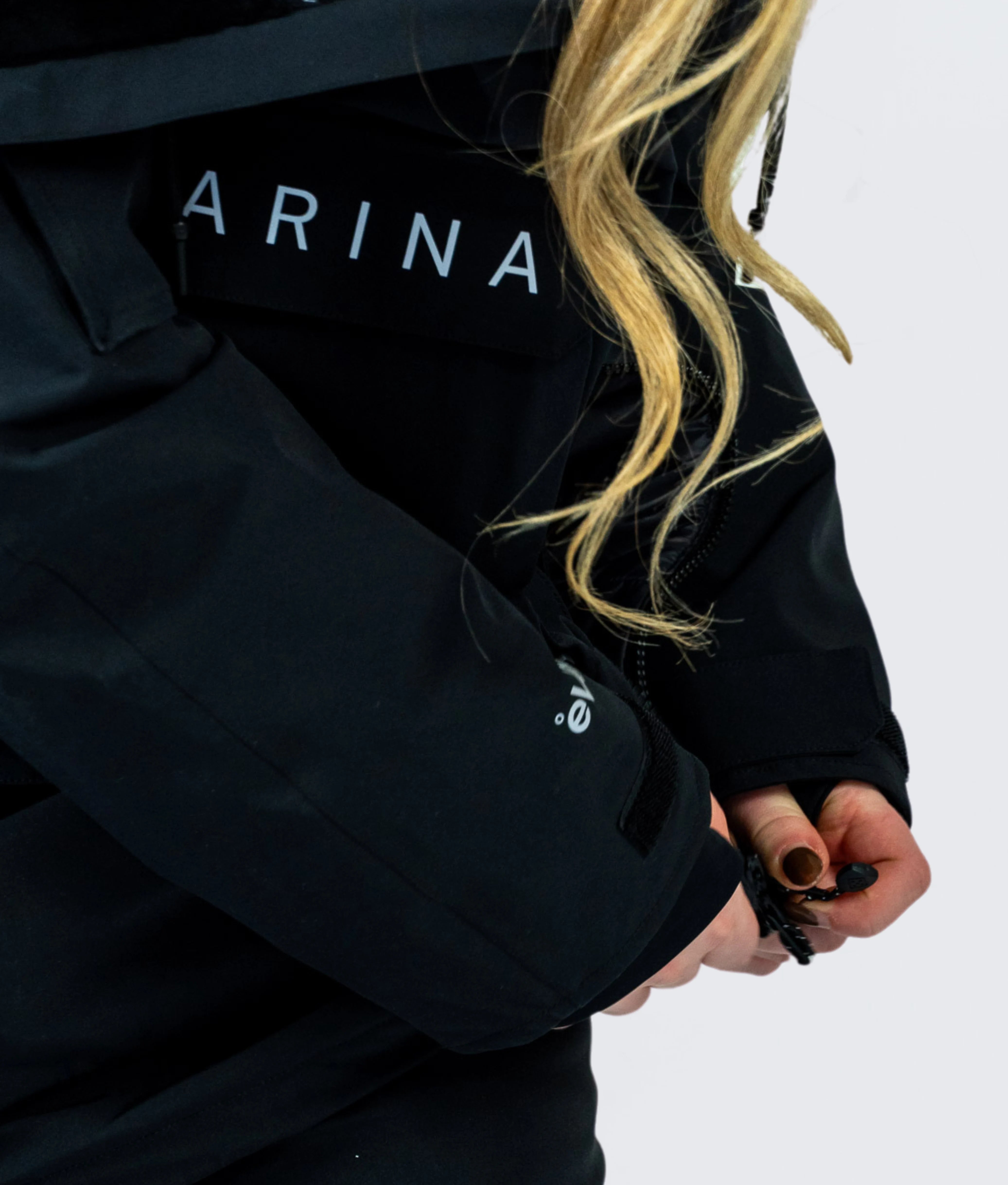 Close-up of Nexarina Indy Snow Jacket being zipped up, with eVent® sleeve detail and drawcord in use.