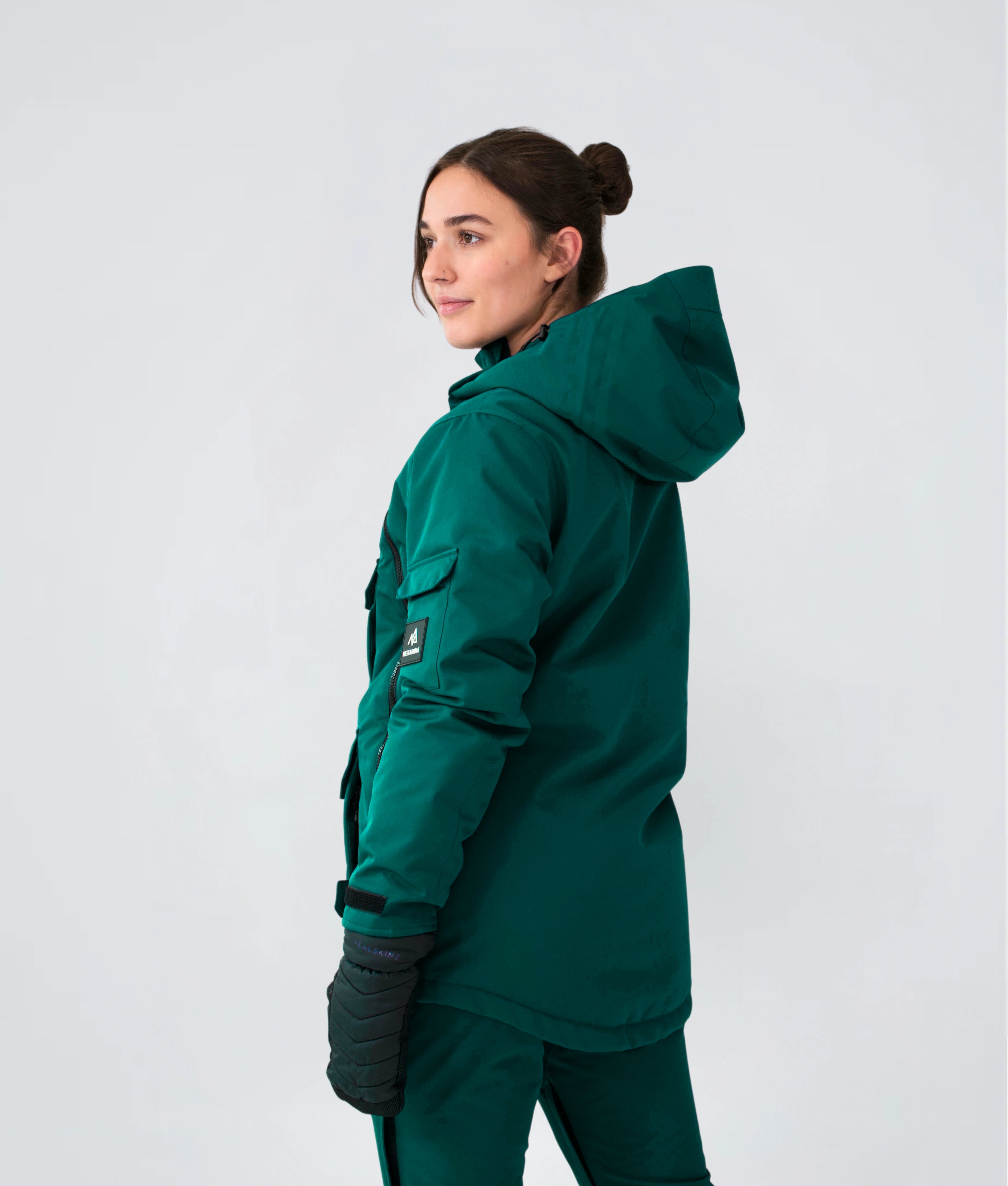 Tall woman wearing Nexarina Indy Snow Jacket in Emerald Green outerwear.