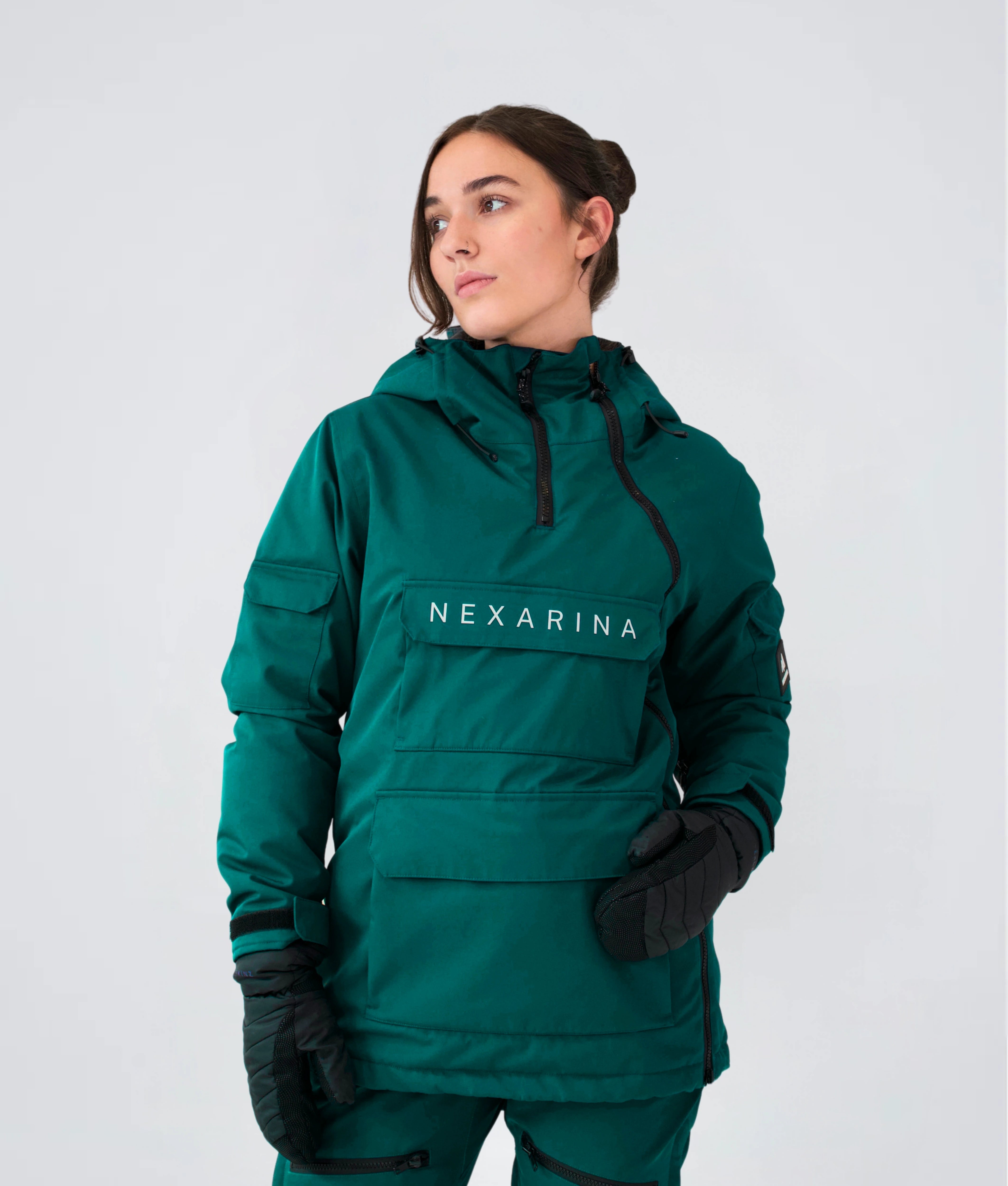 Woman wearing Nexarina Indy Snow Jacket in Emerald Green women’s outerwear.