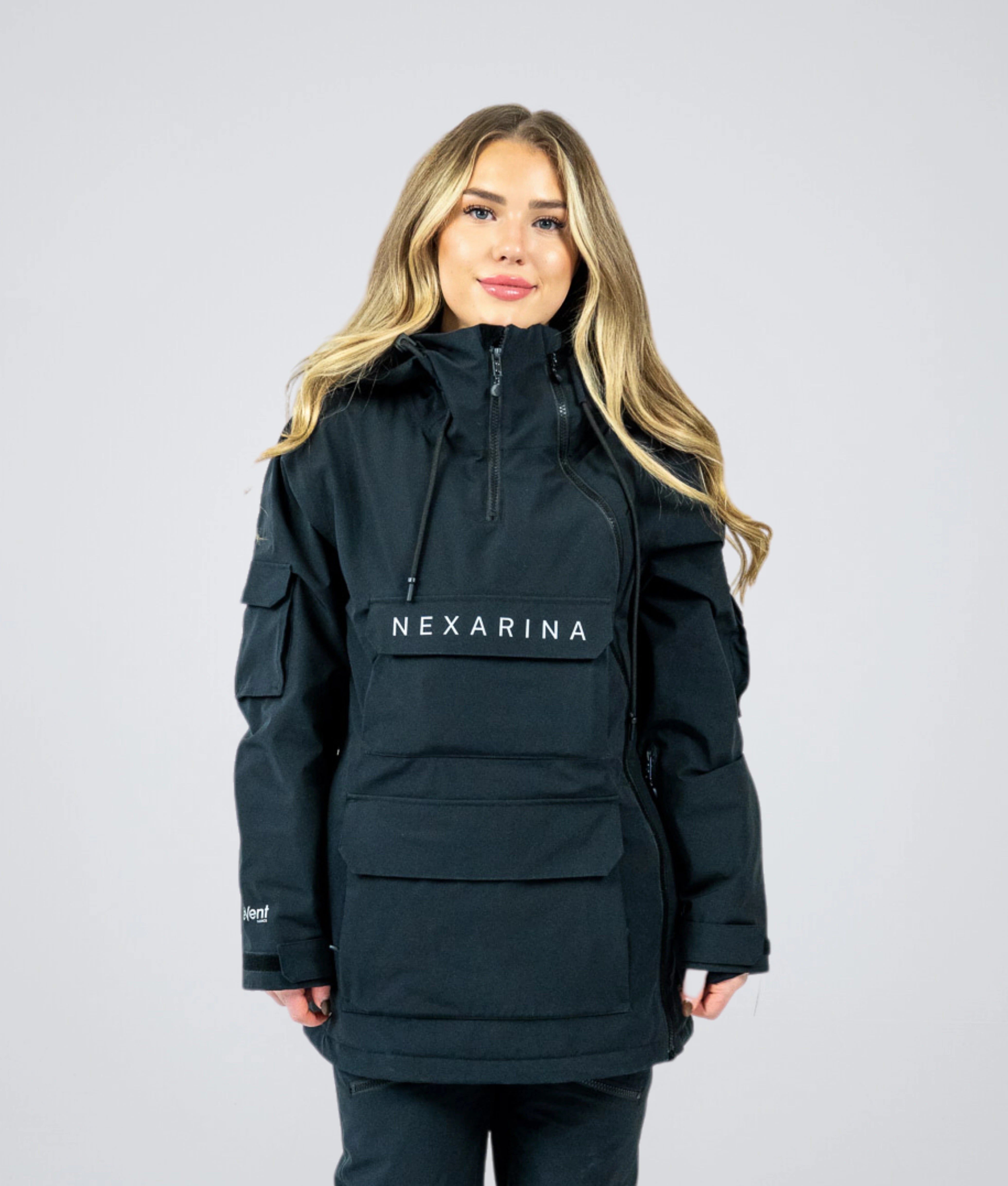 Woman wearing Nexarina Indy Snow Jacket in Classic Black, front-facing studio shot showing full fit and design.