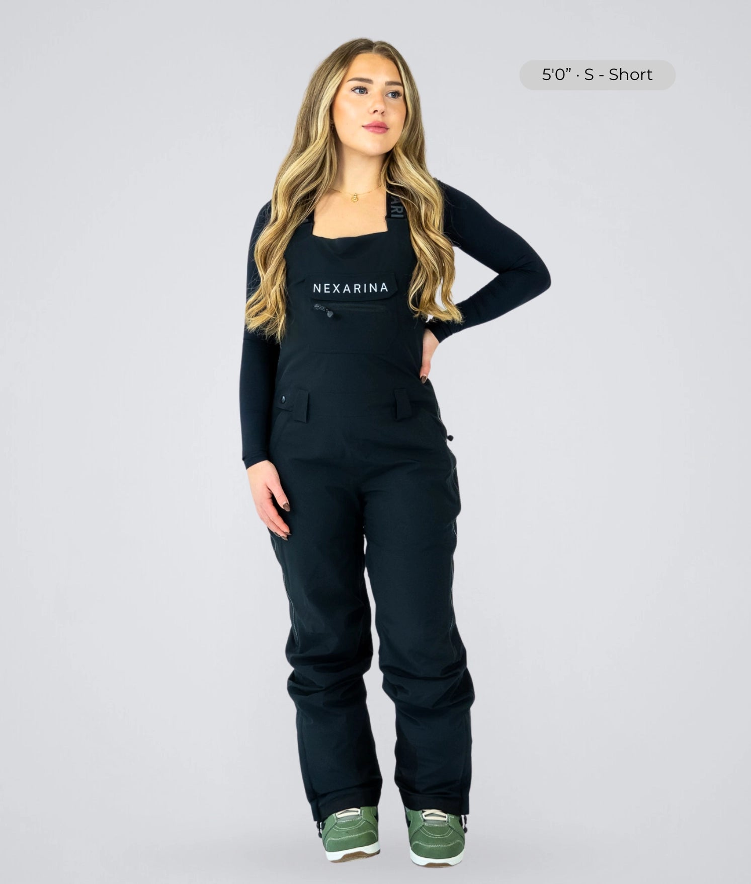 Woman wearing Nexarina Everette women’s black bib snow pants with tailored fit for short women.
