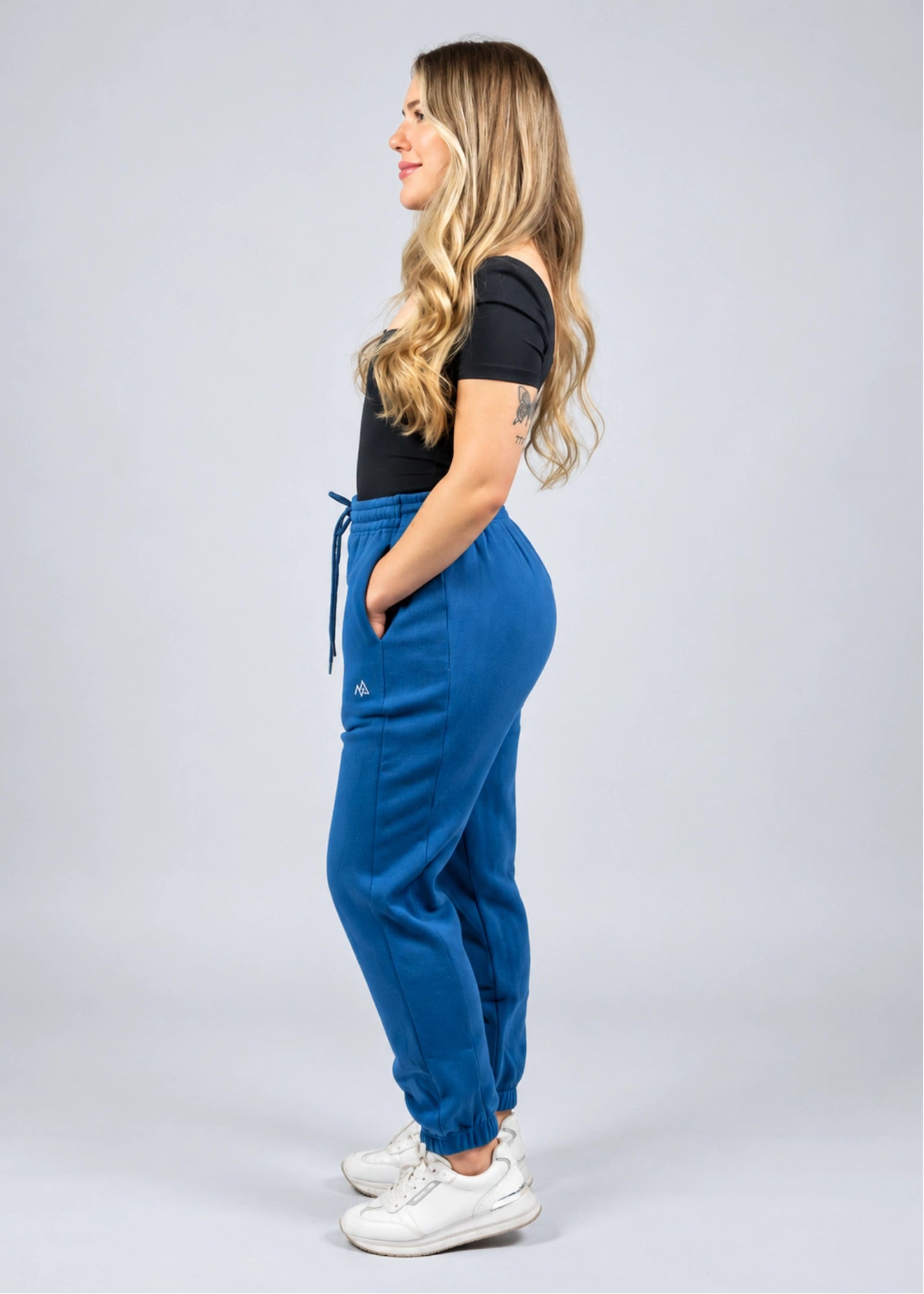 Side view of the women's Willow Sweatpants in Dusty Blue showing the hip fit and side panel.