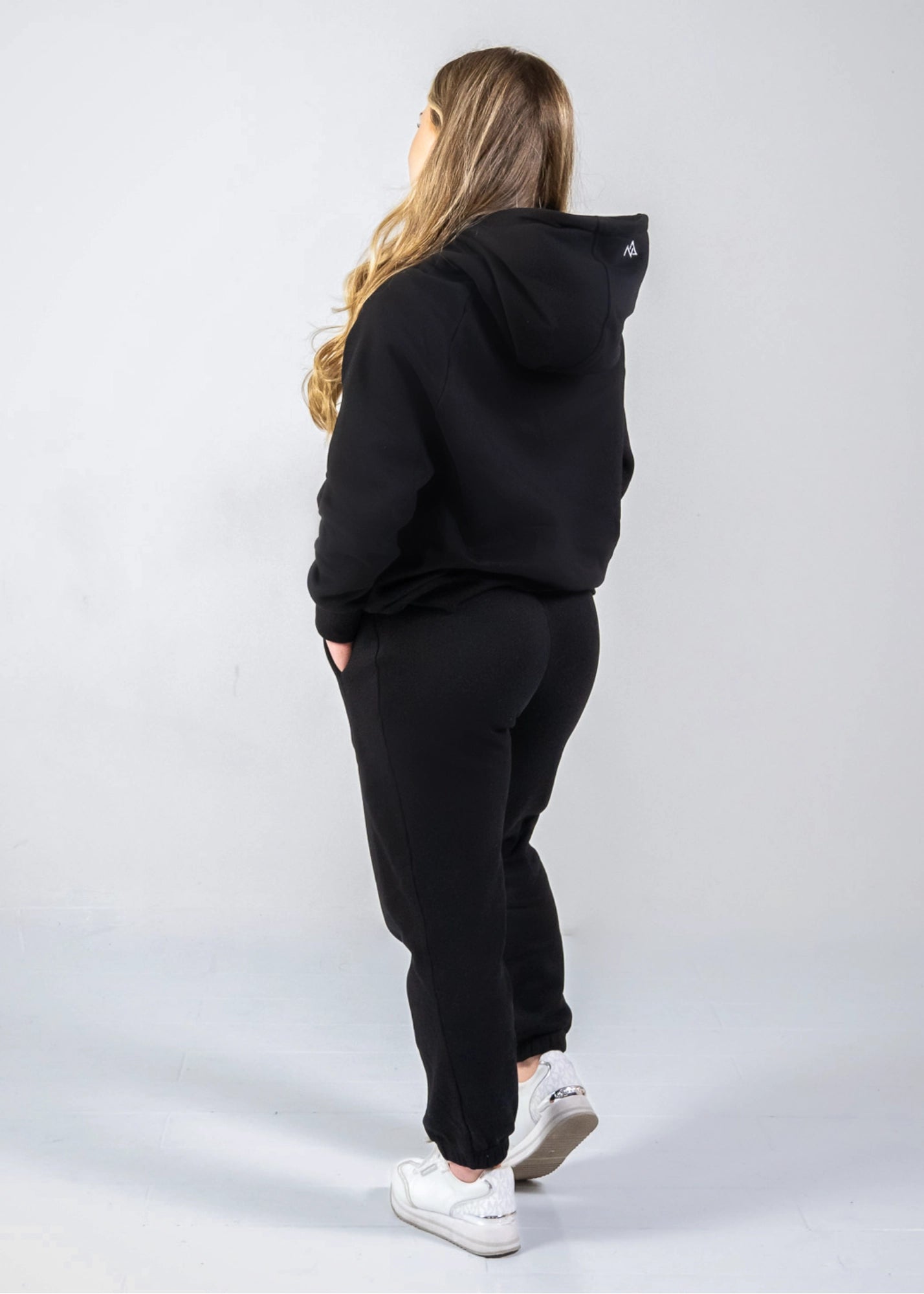 Woman wearing Midnight Black Nexarina sweatpants from the back